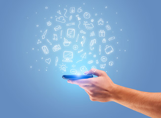 Hand with phone and drawn office icons