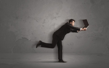 Running businessman with device in hand