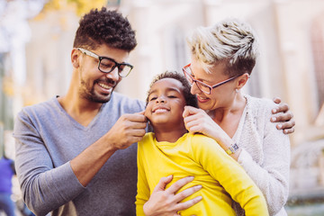 Happy young mixed race couple spending time with their daughter