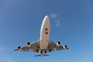 Fototapeta na wymiar Passenger airplane in blue sky background.