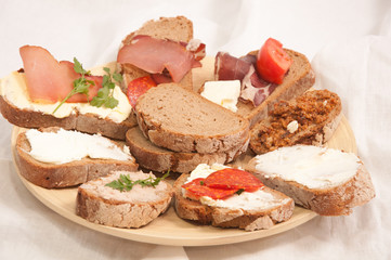 Traditional sandwiches on a wooden plate