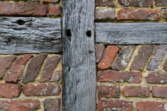 Close-up from old ancient wall with hardwood and red historic bricks background