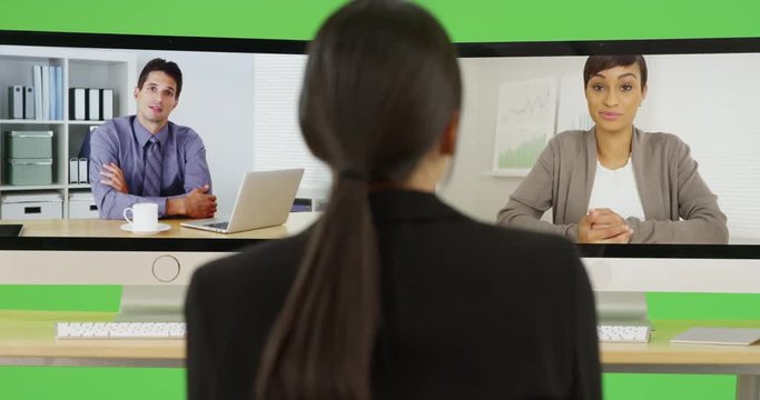 A young businesswoman chats with her office peers on green screen. On green screen to be keyed or composited. 