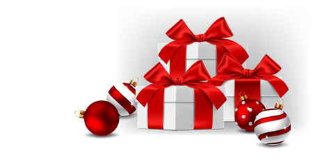Gift boxes with red bows isolated and balls on white background
