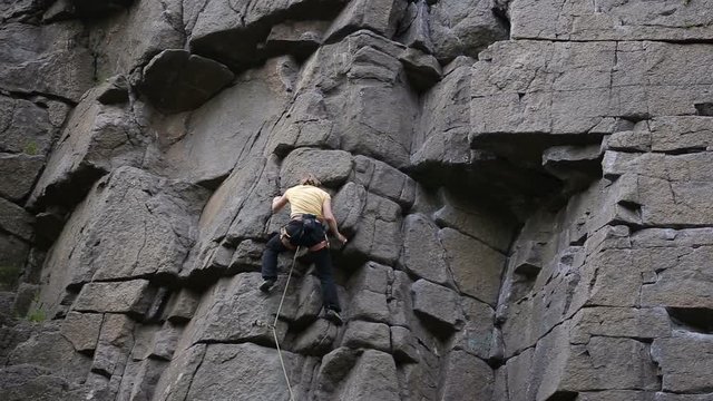 Shot of Rock climber reaches top