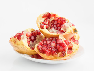 pomegranates on plate isolated on white