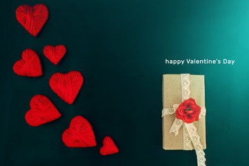 valentines day, red hearts on a dark background with a gift, place for text
