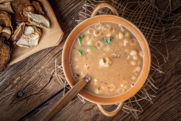 Mushroom soup on a wooden table.