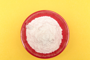 flour in a bowl on a colored background	