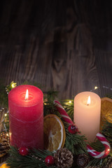 A Couple of Christmas decorated Burning candles on dark wooden rustic background with Copy space 2