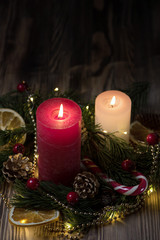 A Couple of Christmas decorated Burning candles on dark wooden rustic background with Copy space 1