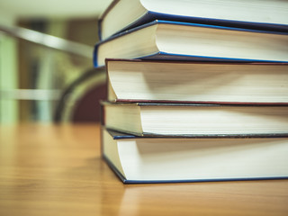 close up shot of stack of books on the table in the library