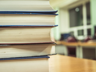 close up shot of stack of books on the table in the library