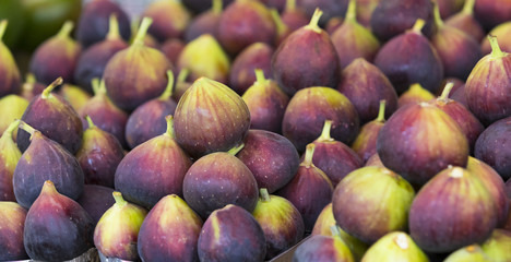 Background of ripe juicy figs on the market stalls shot close-up