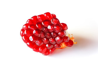 Red ripe pomegranate grains on white background.