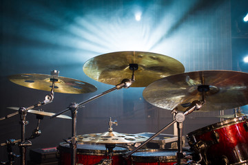 drum set on stage and light background; empty stage with instruments ready for performance