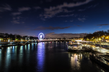 Fototapeta premium Beautiful Dusk over looking The Pont Alexandre III and Ferris Wheel from Pont des Invalides in Paris.