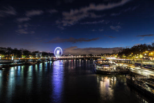 Beautiful Dusk over looking The Pont Alexandre III and Ferris Wheel from Pont des Invalides in Paris.