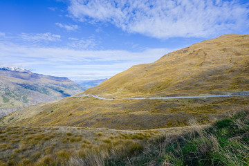 Valley is covered with brown grass in New Zealand