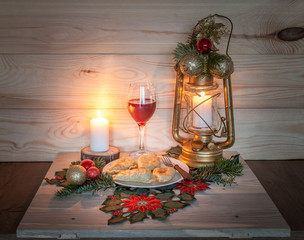 Traditional Christmas homemade dumplings stuffed with mushroom and cabbage on the wood table with a glass of wine