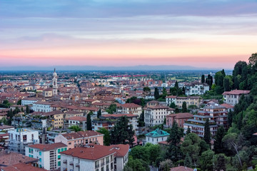 The city of Bergamo's red sky over many small houses