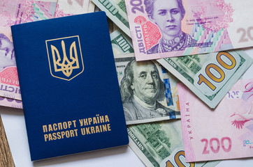 International Ukrainian passport with Hryvna banknotes on US dollars background.