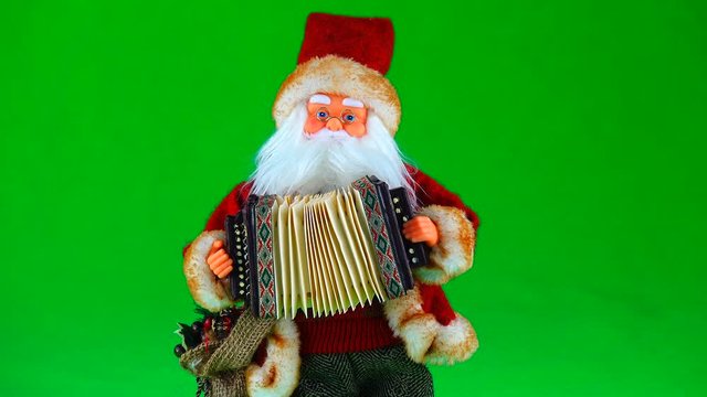 Santa Claus plays a musical instrument on the green screen