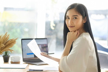 Portrait of a young asian businesswoman sitting at her desk in an office