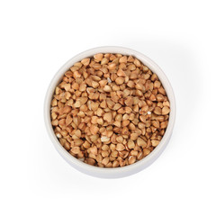 Buckwheat groats in whitebowl isolated on white background