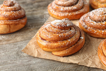 Sweet cinnamon rolls on table