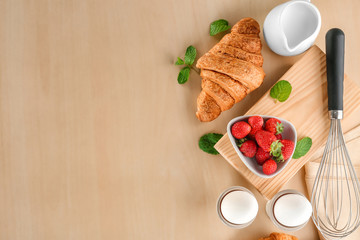 Composition with tasty croissants on wooden background