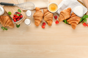 Composition with tasty croissants on wooden background