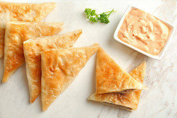 Board with delicious meat samosas, closeup