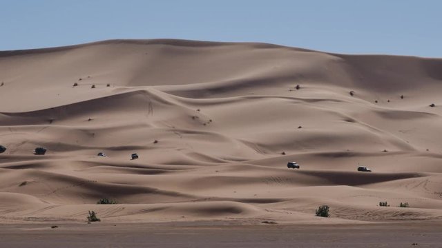 Four wheel drives in the Sahara, traditional entertainment for tourists in Moroccan desert  4K