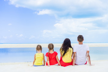 Obraz premium Happy family of four on beach vacation