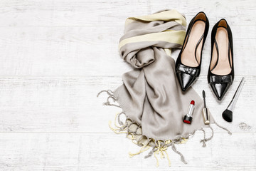 Black shoes, luxurious scarf and cosmetics.