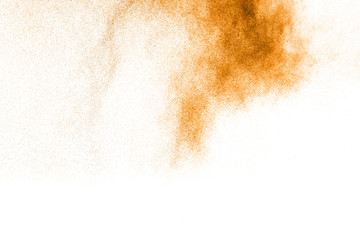 Fototapeta premium abstract orange dust explosion on white background. abstract orange powder splattered on white background, Freeze motion of orange powder splash.