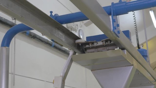 Machinery in food factory sliding along rail