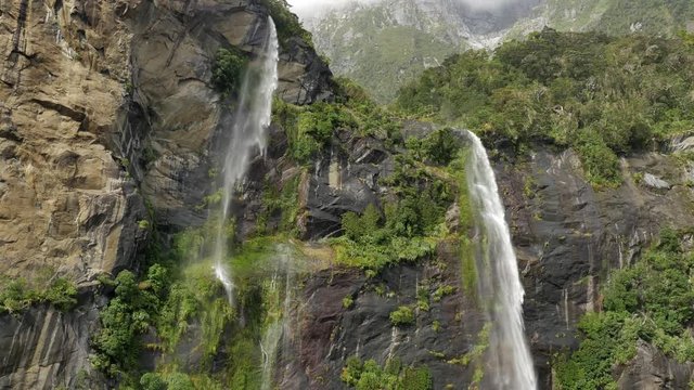 NEW ZEALAND &ndash; MARCH 2016 : Video shot of Milford Sound waterfall on a beautiful day from a boat with mountains in view
