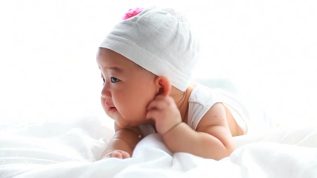 lovely asian baby girl in bed