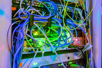 A lot of network wires,  patch panel, messy wires in the server rack