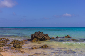 Fototapeta na wymiar Beach stone . Horizon. Emerald water