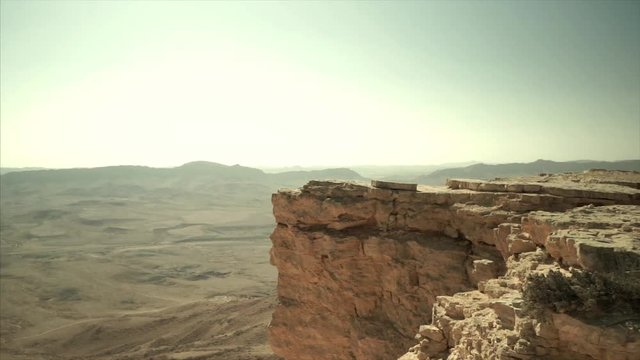 Panning shot of wild negev desert in Israel. Crater mitzpe ramon in wilderness valley. Travel and tourism in middle east