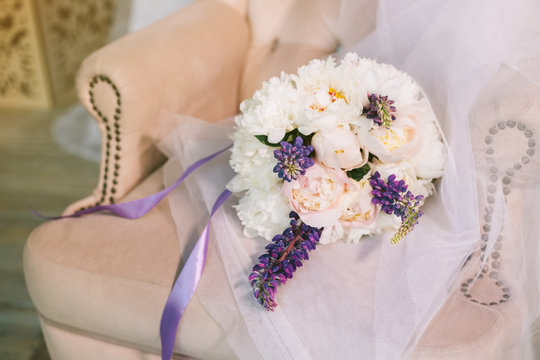 Luxurious wedding bouquet of purple, pink and white flowers. Wedding composition from multi-colored pions in a soft chair. Closeup shot.