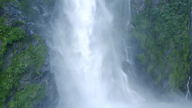 NEW ZEALAND &ndash; MARCH 2016 : Video shot of Milford Sound waterfall on a beautiful day from a boat with mountains and people in view