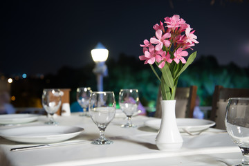 Restaurant table at night with street lamp. This is romantic ambient