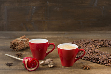 Coffee with foam in a cup on a wooden surface