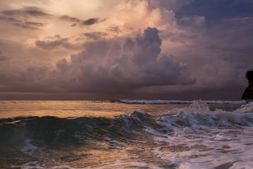 Cinematic aerial shot of the dramatic coastline at sunset time. Exotic place, paradise - island Bali. Beautiful ocean landscape. Orange and pink cloud, colorful sky.