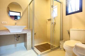Luxury bathroom features basin, toilet bowl and bathtub