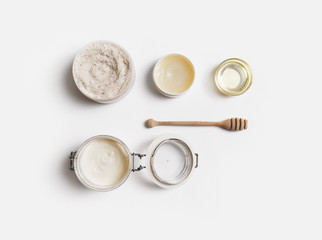 Beauty treatment products on white paper background. Spa cosmetic concept. Flat lay.